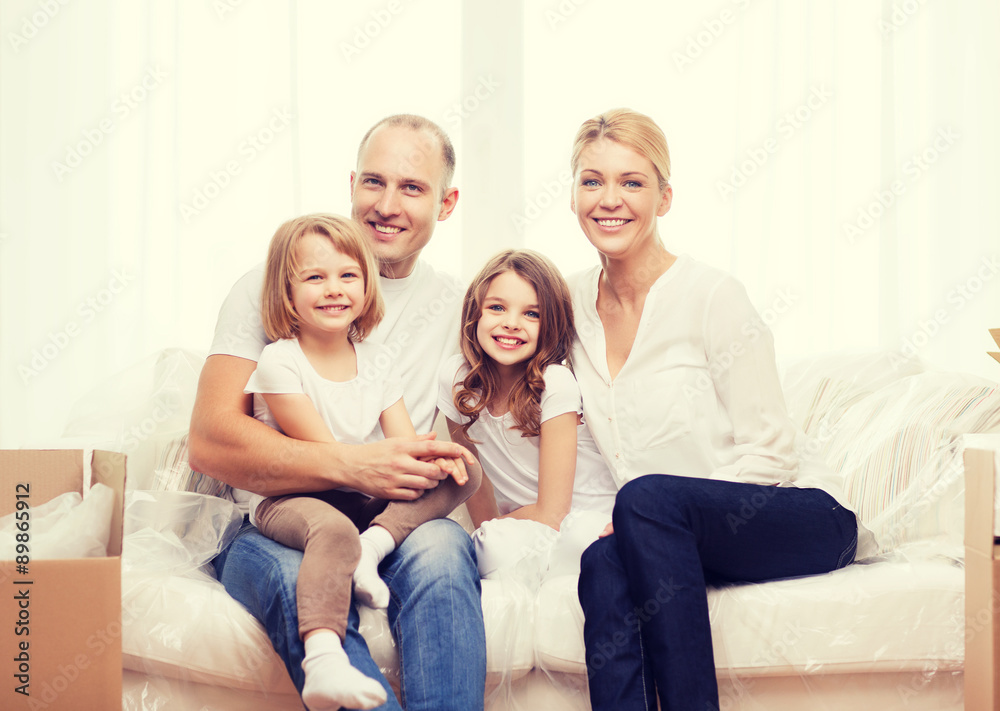 smiling parents and two little girls at new home