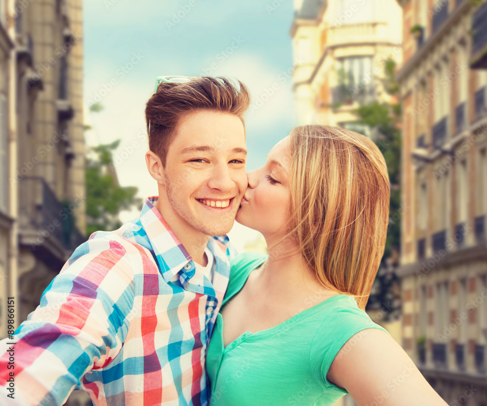 happy couple taking selfie over city background happy couple taking selfie over city background