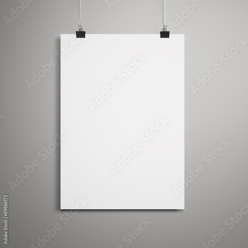 Blank paper poster on gray wall © shuruev