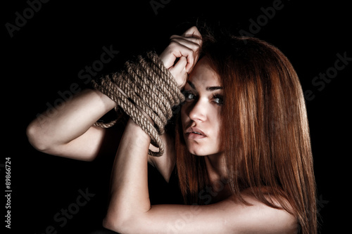 Фотография Beautiful young woman with tied arms