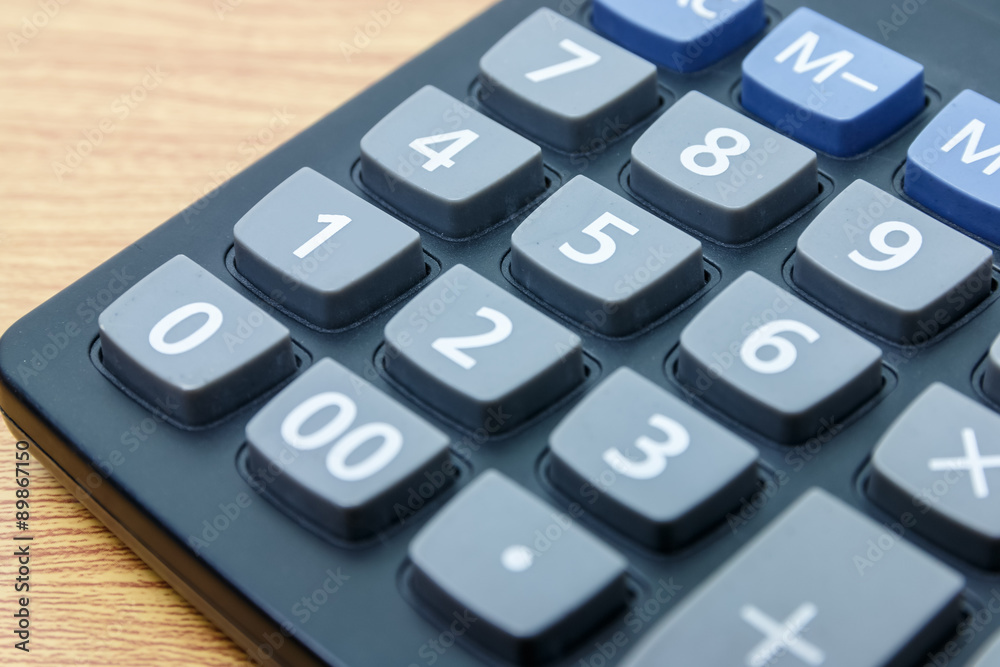 calculator number one button on a wooden. calculator number one button on a wooden.