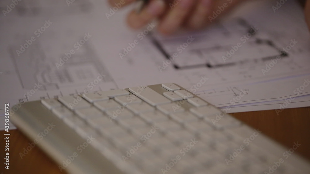 Female Architect Studying Plans In Office, on blueprint Female Architect Studying Plans In Office, on blueprint