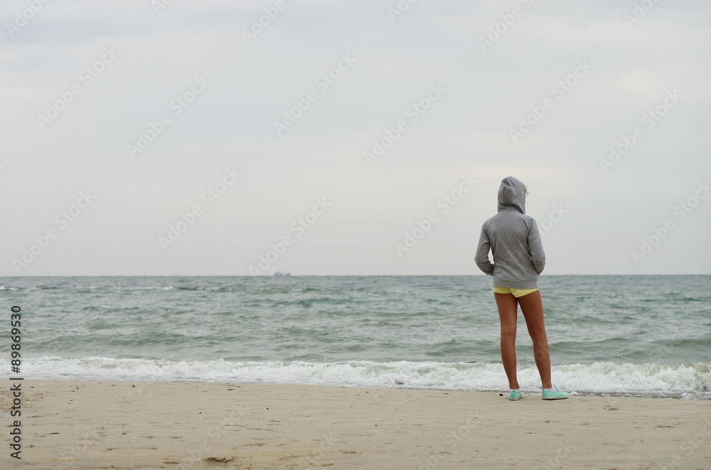the girl on the shore looking at the sea