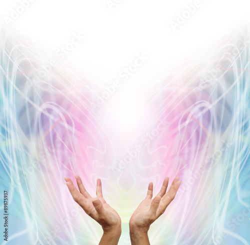 Fototapeta Naklejka Na Ścianę i Meble -  Energy Healer - Female energy worker with hands outstretched and open upwards sensing healing energy on pastel rainbow colored swirling  energy formation background
