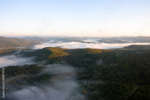 An aerial view of a hot air balloon floating over the Vermont country side ..