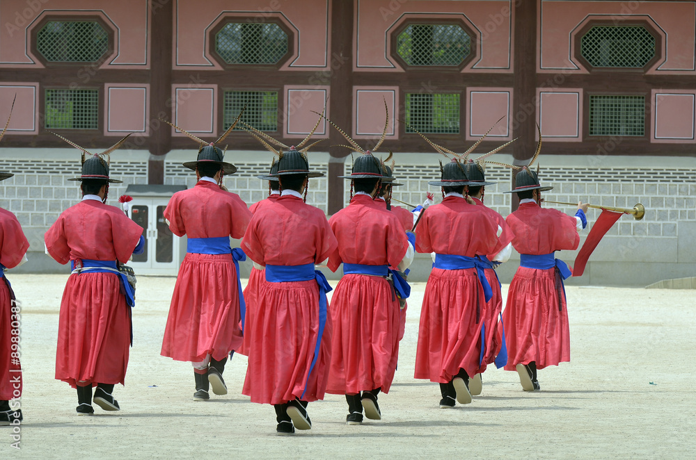 Row of armed guards in ancient traditional soldier uniforms in the old royal residence, Seoul, South Korea..