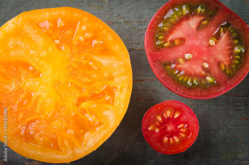 Colorful different kinds of tomatoes on wooden background Colorful different kinds of tomatoes on wooden background