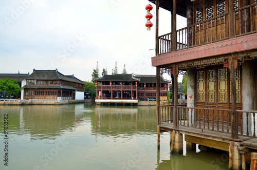 Canvas Print Old village by river in Shanghai with boat..