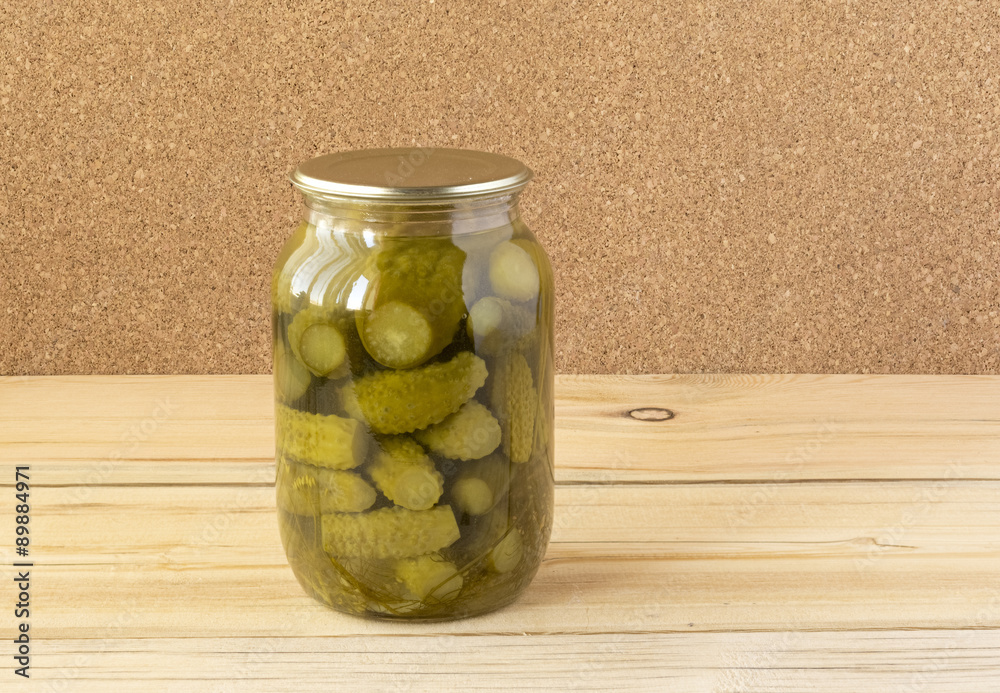 A glass jar with salted cucumbers A glass jar with salted cucumbers