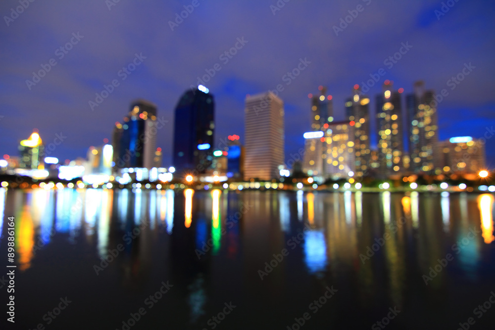 Blur reflection of the city in the lake / out focus of the city