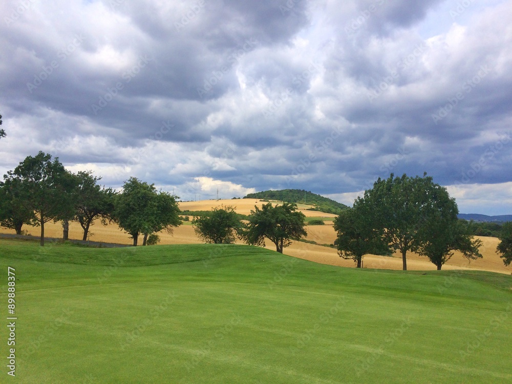 On the empty golf course before rain