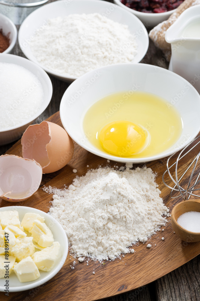 prepared fresh baking ingredients on a wooden board, vertical prepared fresh baking ingredients on a wooden board, vertical