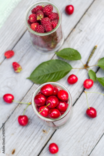Fruits cherries raspberries wooden table