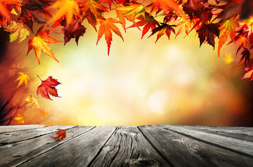 Autumn background with red leaves wooden planks