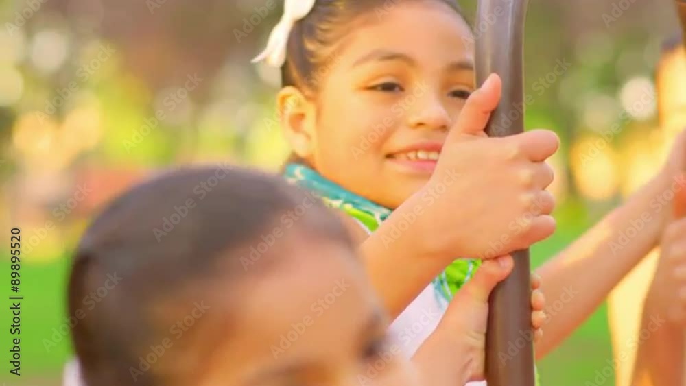 Young girls playing on a merry-go-round
Young girls playing on a merry-go-round
