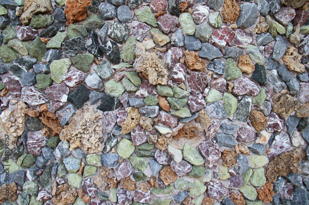 Wall from multi-colored stones Wall from multi-colored stones
