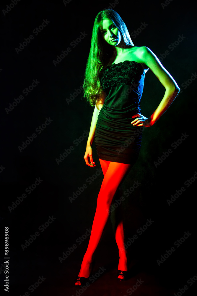 Beautiful young woman in green and red lights