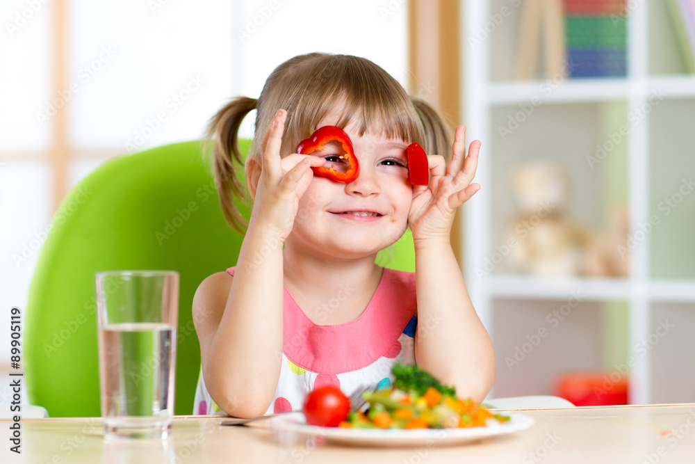 kid girl having fun with food vegetables in children room kid girl having fun with food vegetables in children room