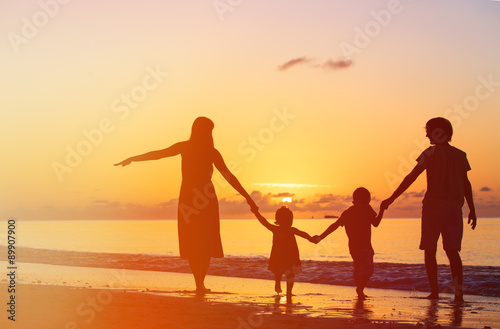 happy family with two kids having fun at sunset 