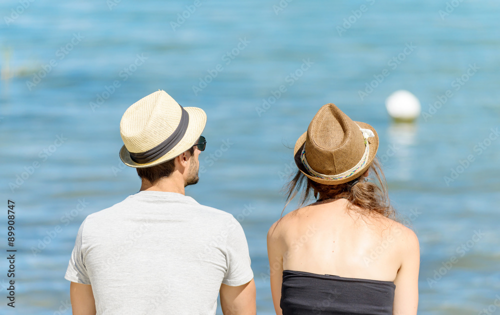  couple, back view, sitting near the water