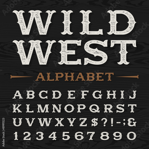 Western style retro distressed alphabet vector font. Serif type dirty letters, numbers and symbols on a dark wood textured background. Vintage vector typography for labels, headlines, posters etc.