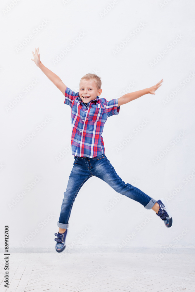 happy young boy jumping  on white background