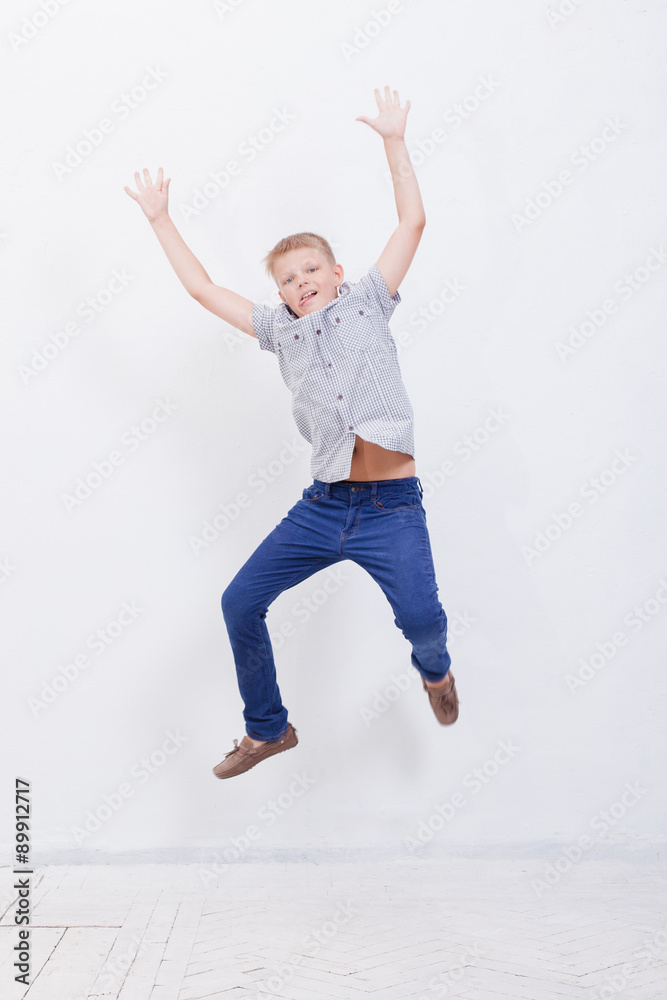 happy young boy jumping on white background happy young boy jumping on white background