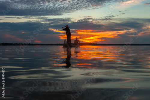 Silhouette fisherman with net at the lake in Thailand © JKLoma