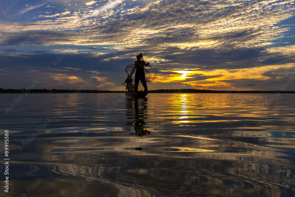 Silhouette throwing fishing net during sunrset, Thailand