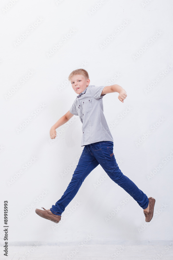 happy young boy jumping on white background happy young boy jumping on white background