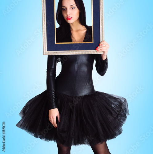 Woman wearing in black dress holding picture frame