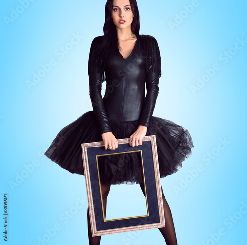Woman wearing in black dress holding picture frame