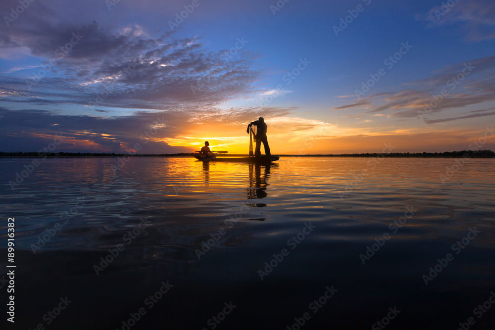 Silhouette throwing fishing net during sunrset, Thailand Stock Photo