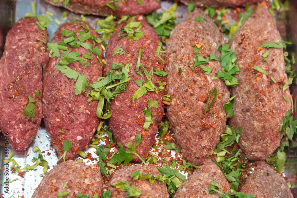 semi-finished products kebab strewed with parsley on a counter of shop semi-finished products kebab strewed with parsley on a counter of shop