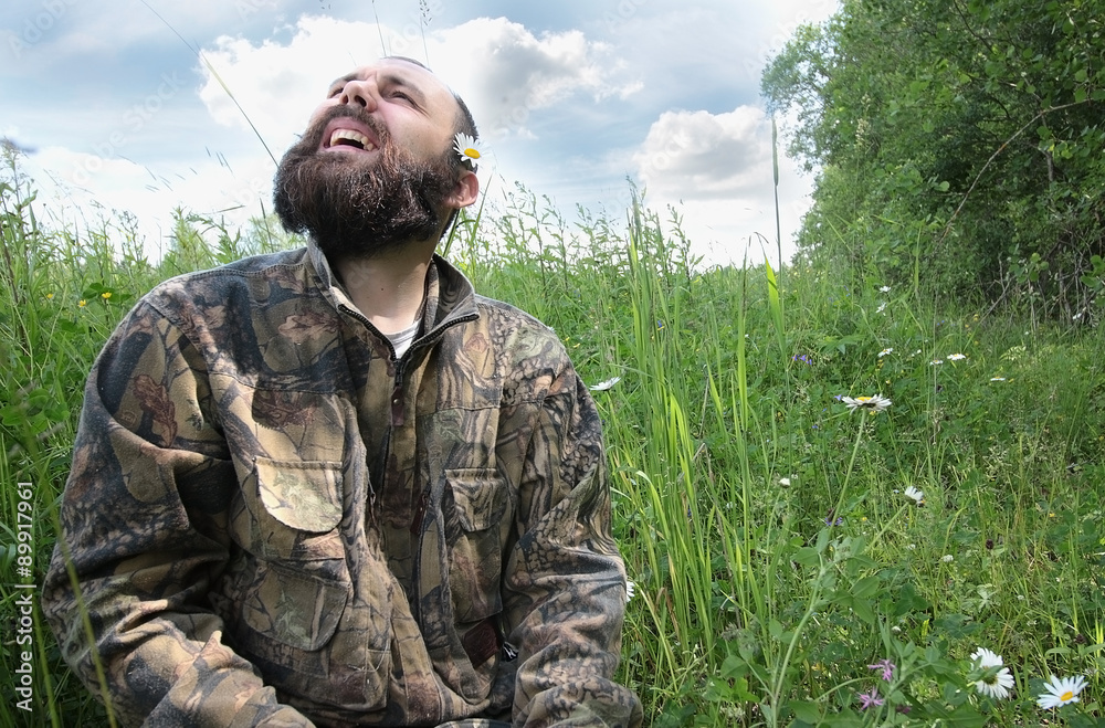 bearded man in the field with chamomile