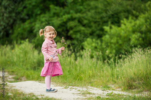 Cute little girl on the meadow 