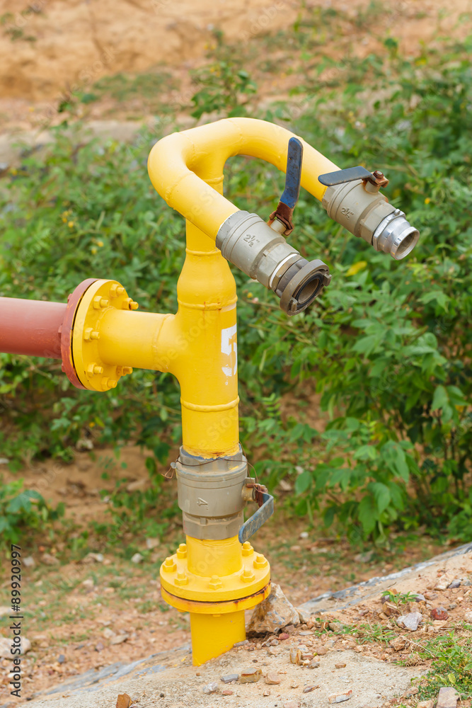 yellow valve water pump and red pipe line on nature background