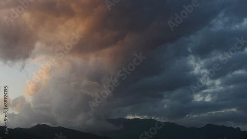  storm clouds illuminated by the light of sunset over the mountains   photo