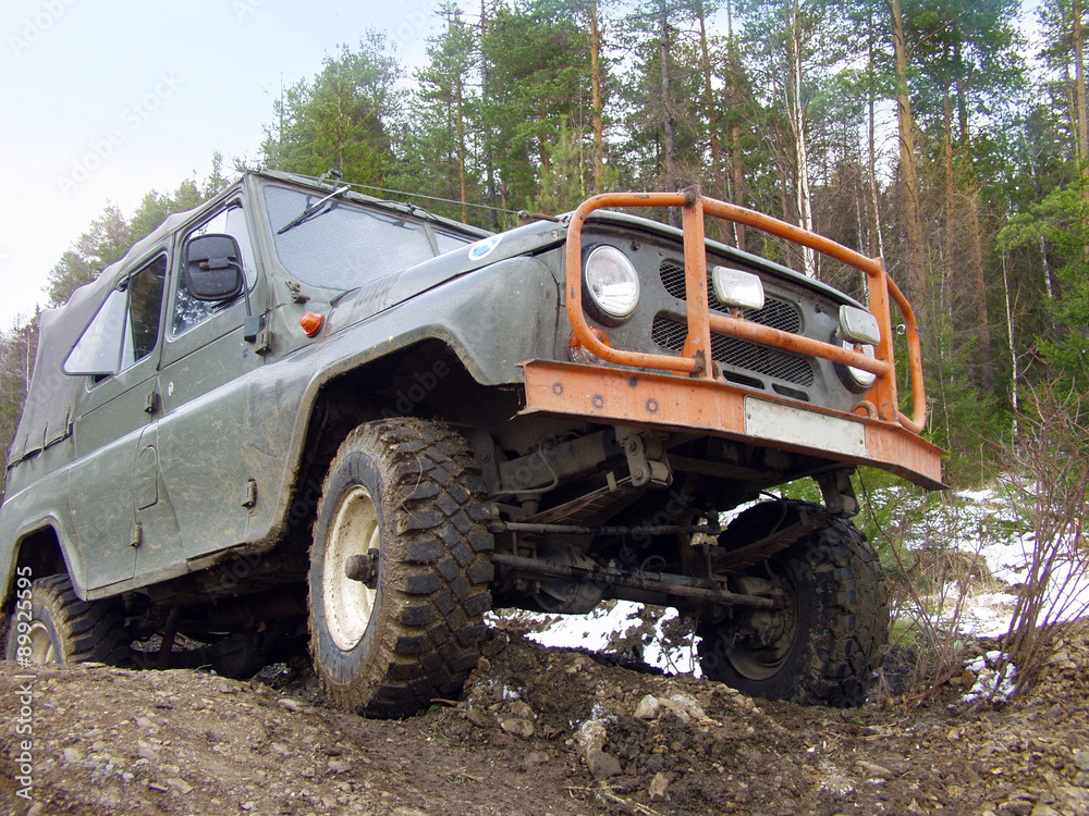 Russian Plain Road in the heart of Siberia. Wheel drive vehicle leaves the swamp