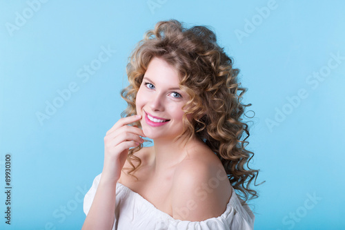 Portrait of pretty woman on a blue background.