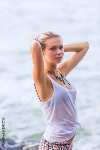 Beautiful young blonde woman posing outdoor at the rocky sea shore © -Marcus-