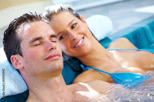 Young couple relaxing in jacuzzi. © grinny