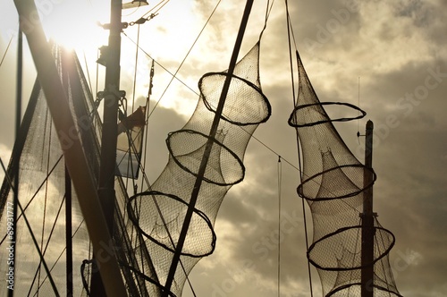 Fishing nets hanged on the mast of a fishing boat photo