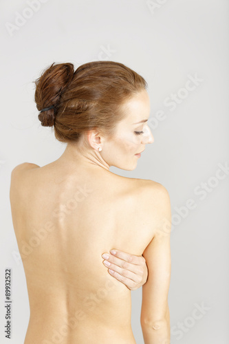 Woman with back ache massaging