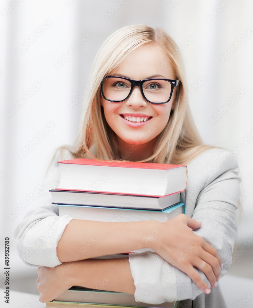 student with stack of books student with stack of books