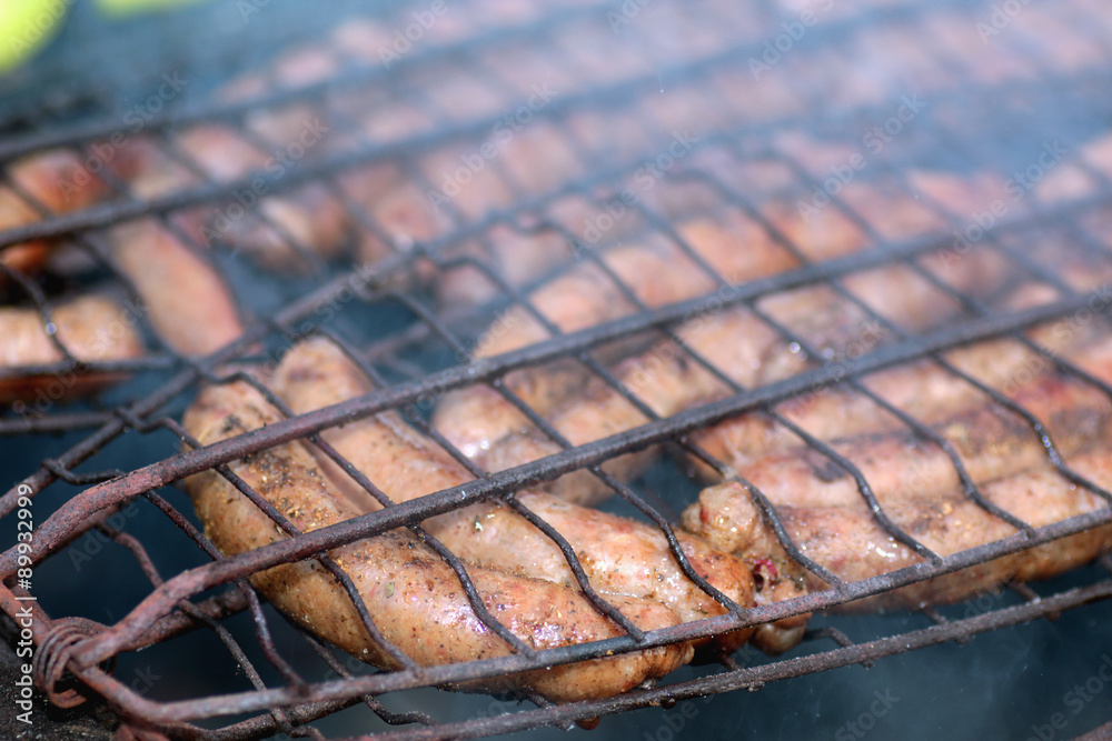 preparing sausages on fire