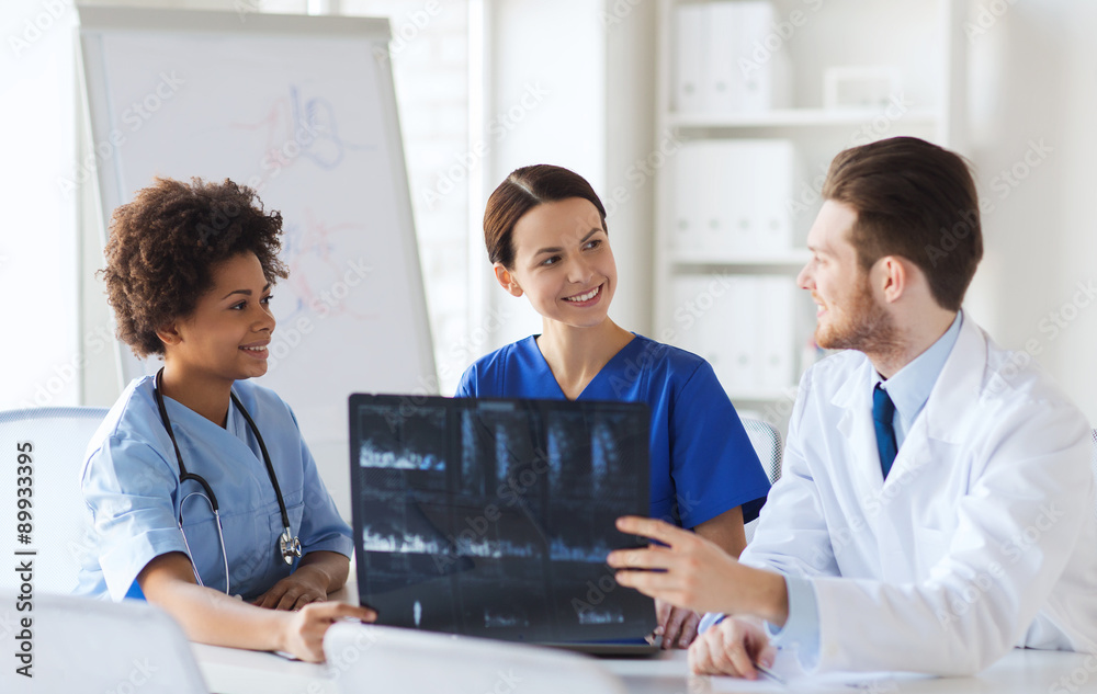 group of happy doctors discussing x-ray image group of happy doctors discussing x-ray image