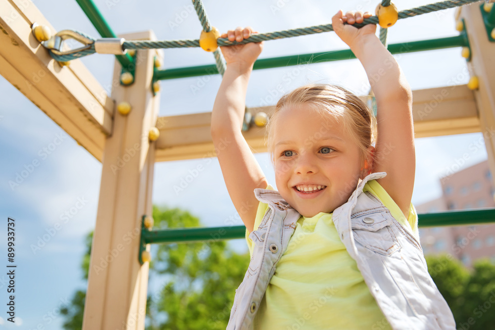 happy little girl climbing on children playground happy little girl climbing on children playground