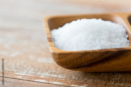 close up of white salt heap in wooden bowl