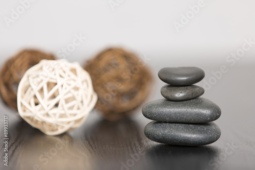 Pile of three spa stones with three scented wicker balls